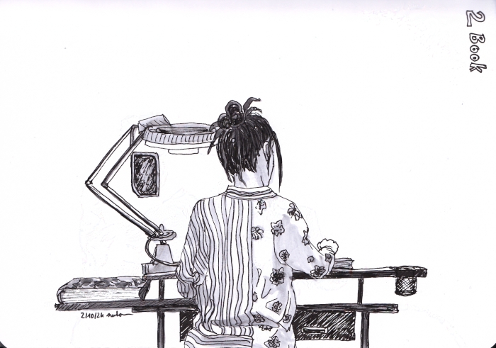 woman seen from behind in front of her workstation